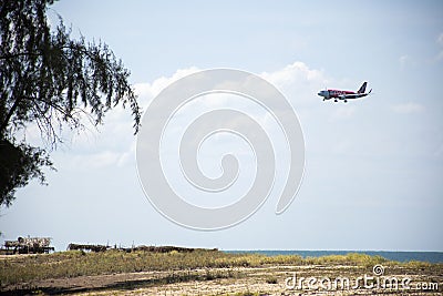 View landscape and airplane boeing flying pass Banton Beach and village go to landing on runway at Narathiwat airport at on August Editorial Stock Photo