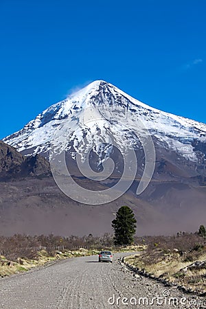 View of the Lanin Volcano from the road to Tromen Lake in Neuquen, Argentina. This volcano is covered by eternal snow Stock Photo