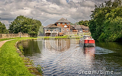 A view of Leeds Liverpool canal with a barge in Blackburn Stock Photo