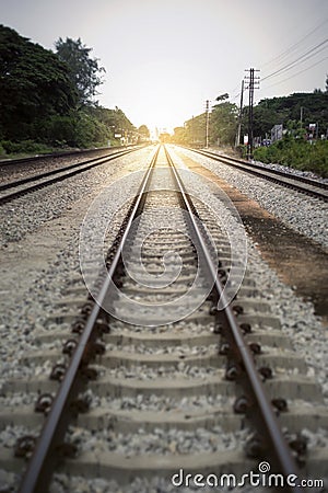 View of the length of railway with green tree at left and right side of railway,filtered image, light effect added Stock Photo