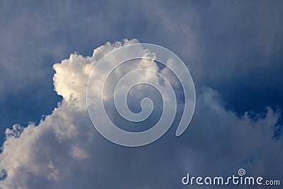 LIGHT FALLING ON THE TOP OF THE A LARGE WHITE CLOUD Stock Photo