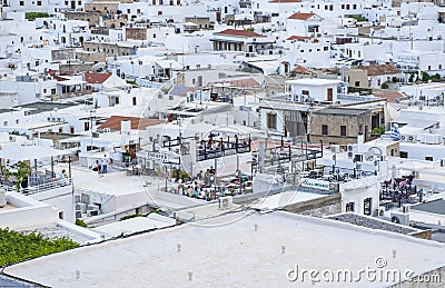 View from the Lindos Acropolis of Roof Top Restaurants Filled with People in the Village Below Editorial Stock Photo