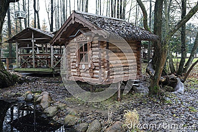 View of log cabin near pond Stock Photo