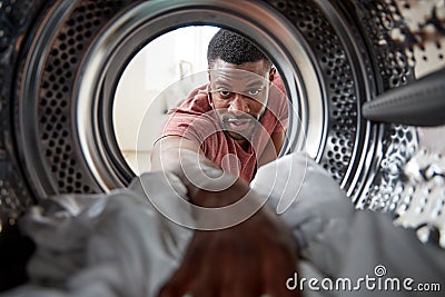 View Looking Out From Inside Washing Machine As Man Does White Laundry Stock Photo