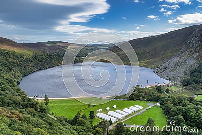 View on Lough Tay with a movie set related to Viking era with longships and village Stock Photo