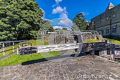 A view the lower of three locks gates on the Leeds, Liverpool canal at Bingley, Yorkshire, UK Stock Photo