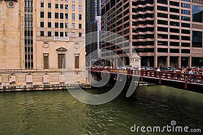 View of Madison Street bridge over Chicago River alongside the Lyric Opera House, as pedestrians/commuters rush to catch transport Editorial Stock Photo