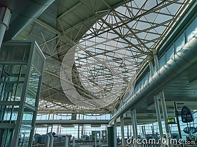 View of the main lobby of SÃ¡ Carneiro Airport, ceiling with metallic lattice structure and glass opening in the ceiling, Porto, Editorial Stock Photo