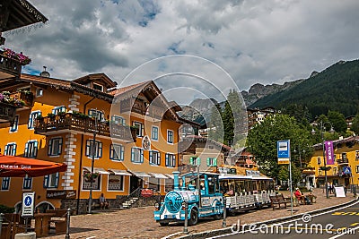 View of the main square of Moena with touristic train Editorial Stock Photo