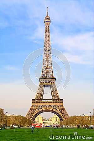 View of the majestic Eiffel Tower that rises from its park to a clear sky. Editorial Stock Photo