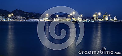 View of Malaga`s port, with lights reflecting in the water surface at blue hour Stock Photo