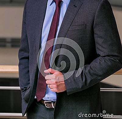 View of a man posing in a blue shirt leaning on the wall - professionalism concept Stock Photo