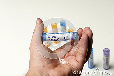 view of man's hand holding a bottle of homeopathic pills. alternative medicine concept. medical care Stock Photo