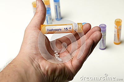 view of man's hand holding a bottle of homeopathic pills. alternative medicine concept.medical care Stock Photo