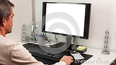 View of man using computer monitor with mockup image blank screen with white background for advertising text Stock Photo