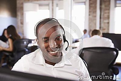 View Of Man Working In Busy Customer Service Department Stock Photo