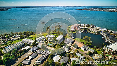 View of many watercraft on Lake Mulwala near the resort houses on the shore of the lake Stock Photo