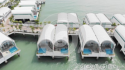 View of a marina with waterfront resort bungalows on a peaceful lake Stock Photo