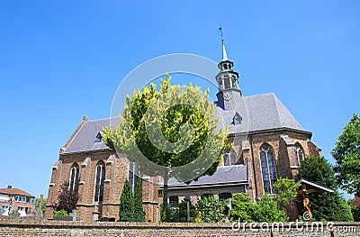 View on medieval church Sint Nicolaaskerk in small dutch village against blue summer sky Editorial Stock Photo