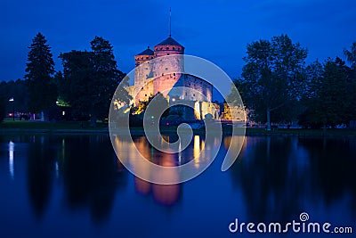 A view of the medieval Olavinlinna fortress of the blue August night. Savonlinna, Finland Stock Photo