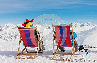 View of men resting on chair in mountains Stock Photo