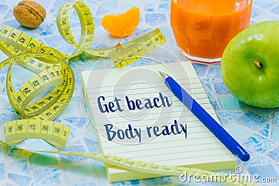 meter to measure waist size, healthy, diet food. Notebook with the motivational slogan `Get beach-body ready`. The concept of spr Stock Photo