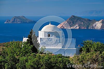 View of Milos island and Greek Orthodox traditional whitewashed church in Greece Stock Photo