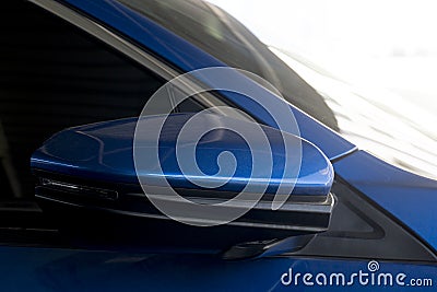 Beside view mirror wing of blur car is foldable parking time. Stock Photo