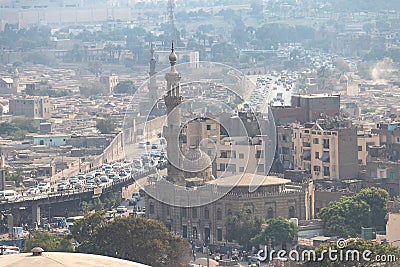 View of misty of city of Cairo in Egypt, due to traffic pollution, over rooftop slums and mosques Stock Photo