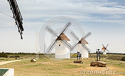 View of Mota del Cuervo with windmills and iron statues of Don Quixote and Sancho Panza Stock Photo