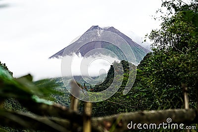 View of Mount Merapi in the morning, and slightly covered by clouds. Potentially eruptive volcano Stock Photo