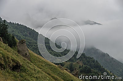 View of mountains in the clouds after storm in valley near Georgian Military Highway. Mtskheta-Mtianeti Region. Georgia, Europe Stock Photo