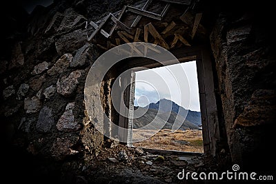 View of the mountains from the window of the abandoned building of the Chukotka Forced Labor Camp, which was part of the Gulag Stock Photo