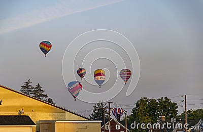 View of Multiple Multi Colored Hot Air Balloons Floating in a Beautiful Morning Blue Sky With Thin Clouds Editorial Stock Photo
