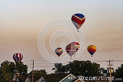 View of Multiple Multi Colored Hot Air Balloons Floating in a Beautiful Morning Blue Sky With Thin Clouds Editorial Stock Photo