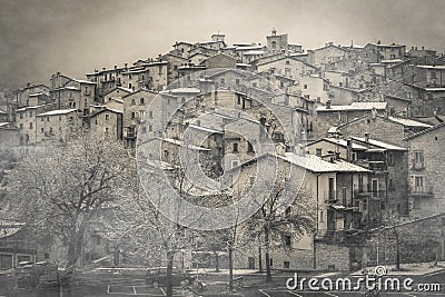 View of mysterious medieval village with fog and snow in winter season, Abruzzo Stock Photo