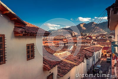 Cusco / Peru - May 27.2008: View on the narrow city street between the houses in downtown during sunset. Editorial Stock Photo