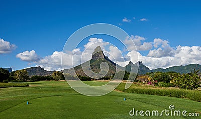 Rempart Mountain overlooking the 2nd Tee of Tamarin Bay Golf Course in Mauritius. Stock Photo