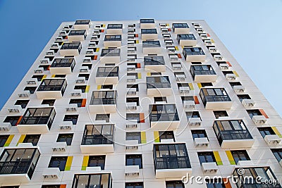 View of the new beautiful white apartment building with orange accents, hinged glazed balconies Stock Photo
