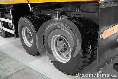 View on new clean rear tipper truck wheels and tires. Mud wheels for commercial transport, special cars. Truck chassis with wheels Stock Photo