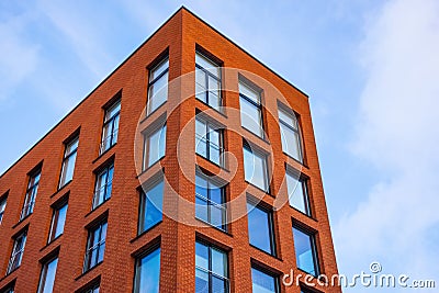 View of a new residential rectangular modern red brick house with classic windows Stock Photo