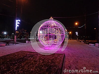 New year street decoration of a spheric form with violet lightning. Stock Photo