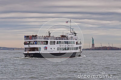 View from New York on the Statue of Liberty and the Statue Cruises boat Editorial Stock Photo