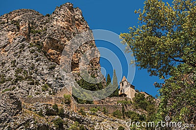 View of the Notre-Dame de Beauvoir church amidst cliffs and rock stairway. Stock Photo