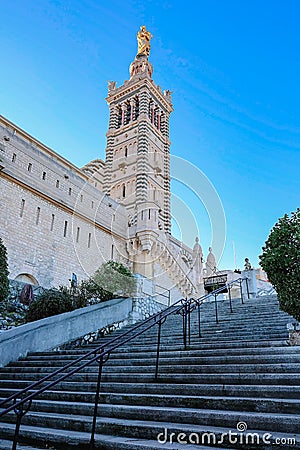 View of Notre Dame de la Garde on top of hill in Marseille. Basilica of Our Lady of Guard with morning rays of sun Stock Photo