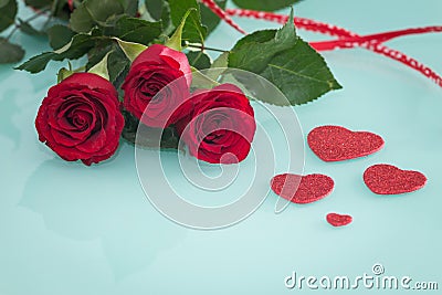 Occasional beautiful red roses with decorative hearts Stock Photo