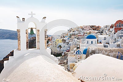 View Of Oia Over Church With Bells In Santorini island, Greece Stock Photo