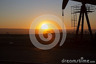 View of Oil Well Pumpjack at Sunset Oil Industry Stock Photo