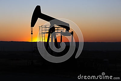 View of Oil Well Pumpjack at Sunset Oil Industry Stock Photo