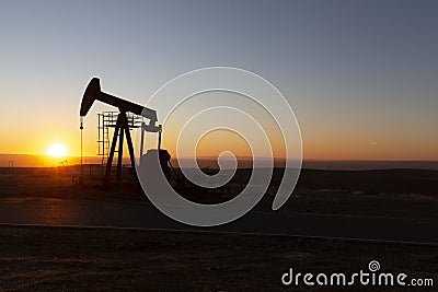 View of Oil Well Pumpjack at Sunset Oil Industry Stock Photo